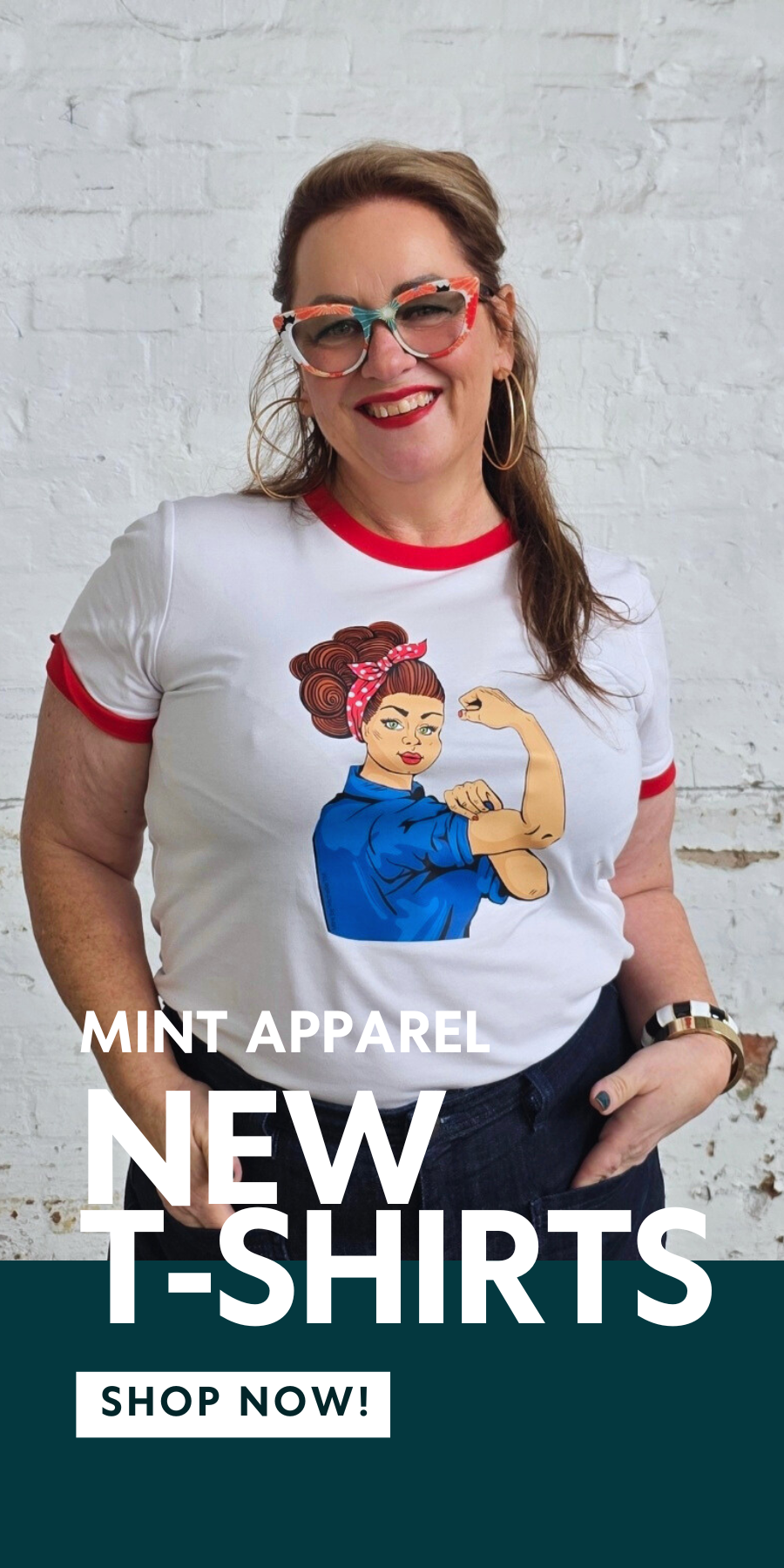 Woman wearing a t-shirt with a graphic design, standing against a white brick wall. New t-shirts from Mint Apparel.